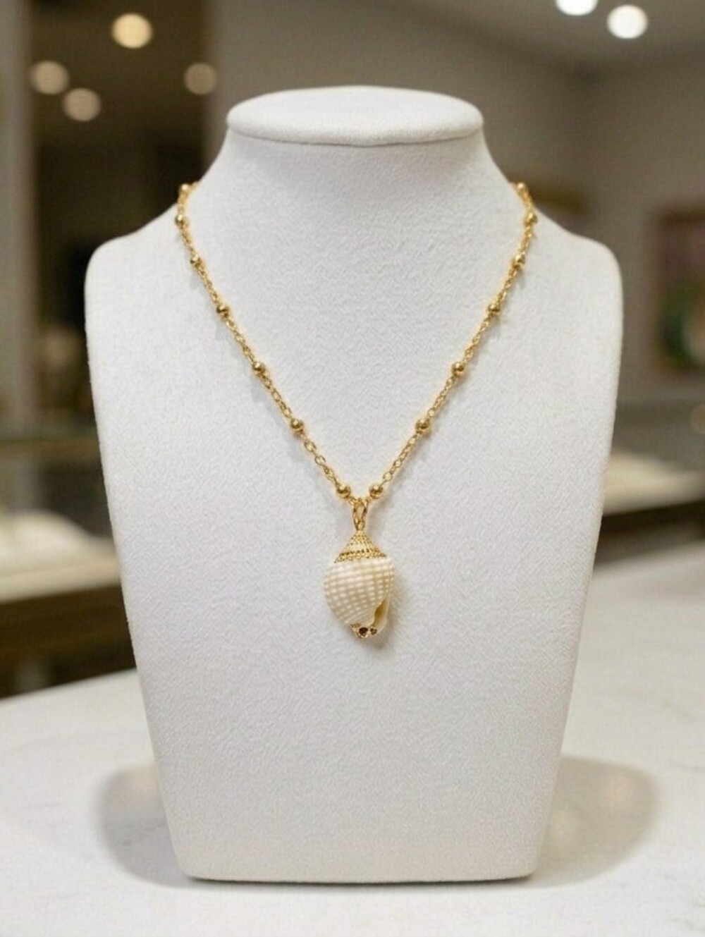 The Signature Gilded Nassa Shell Pendant Necklace
